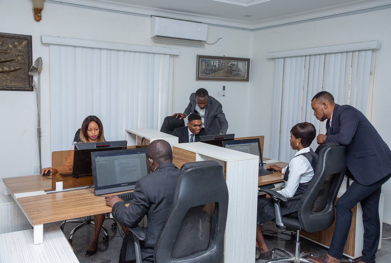 A group of professionals working together in a modern office setting, emphasizing teamwork and productivity.