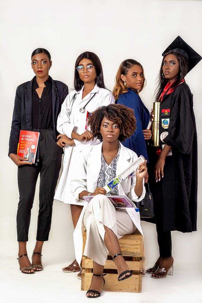 mobile-02 Five women in diverse professional outfits pose confidently against a white background.